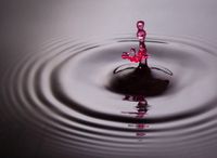 Red water drop hand shaped splash